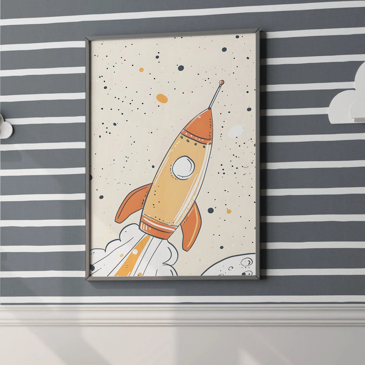 Framed rocket ship nursery wall art with orange and beige spaceship on gray striped wall