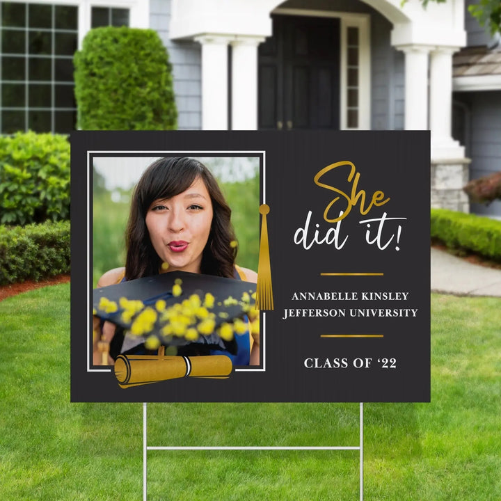 Graduation yard sign with photo of woman throwing confetti, text She did it, name Annabelle Kinsley, class of 22