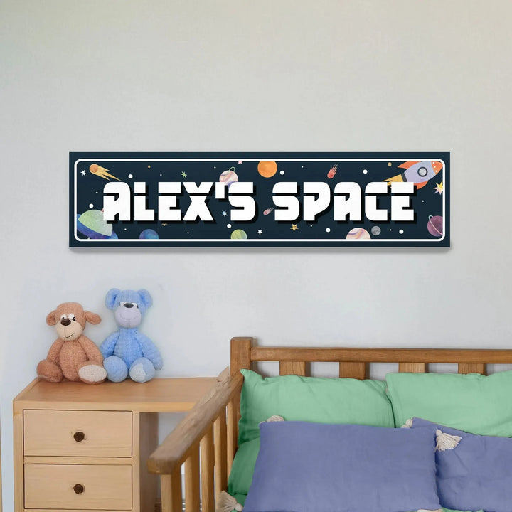 Personalized space-themed metal sign reading 'Alex's Space' with planets and rocket above wooden bed