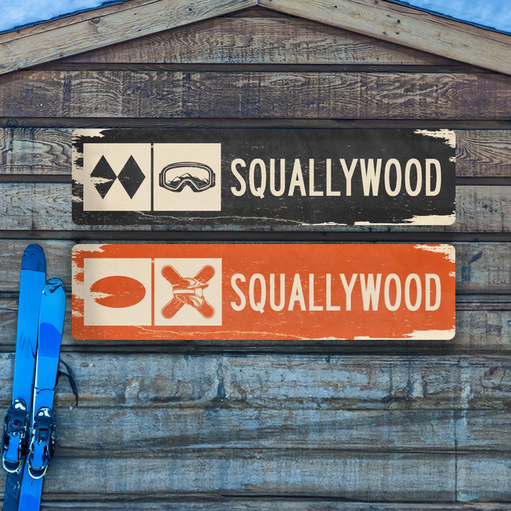 Distressed metal ski trail signs reading Squallywood with sunglasses and crossed skis icons on wood wall with blue skis