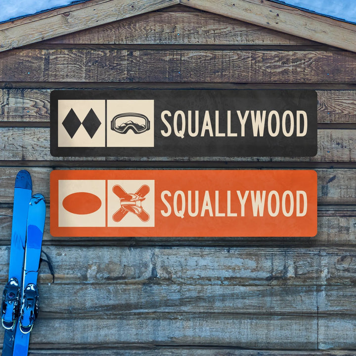 Two Squallywood ski trail metal signs on wood wall with blue skis leaning against it