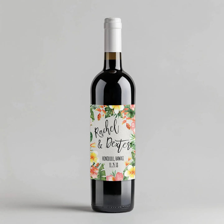 Tropical wedding wine bottle with custom floral label and names, Honolulu Hawaii theme.