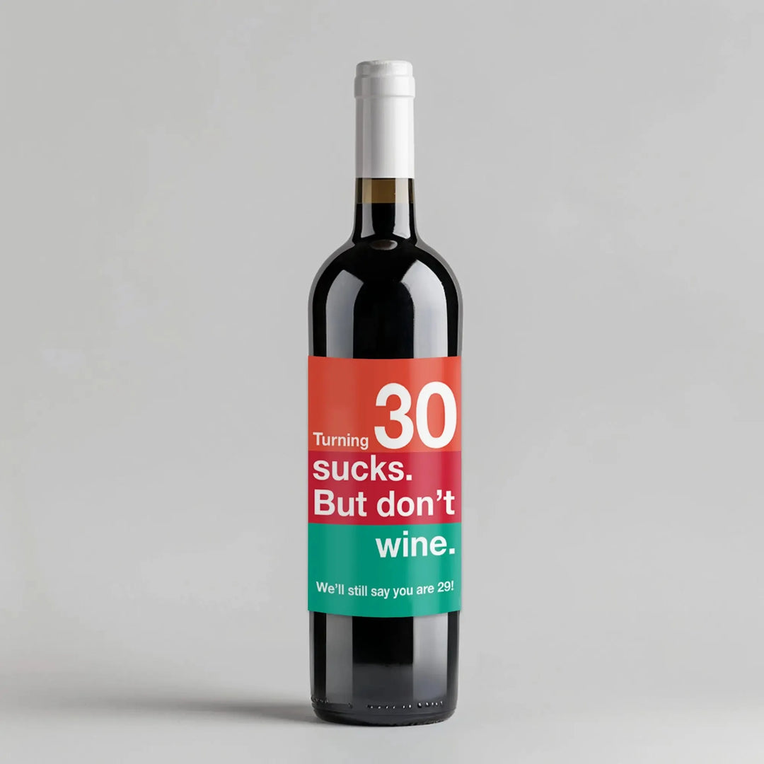 Funny turning 30 birthday wine bottle with colorful label and humorous message on gray background