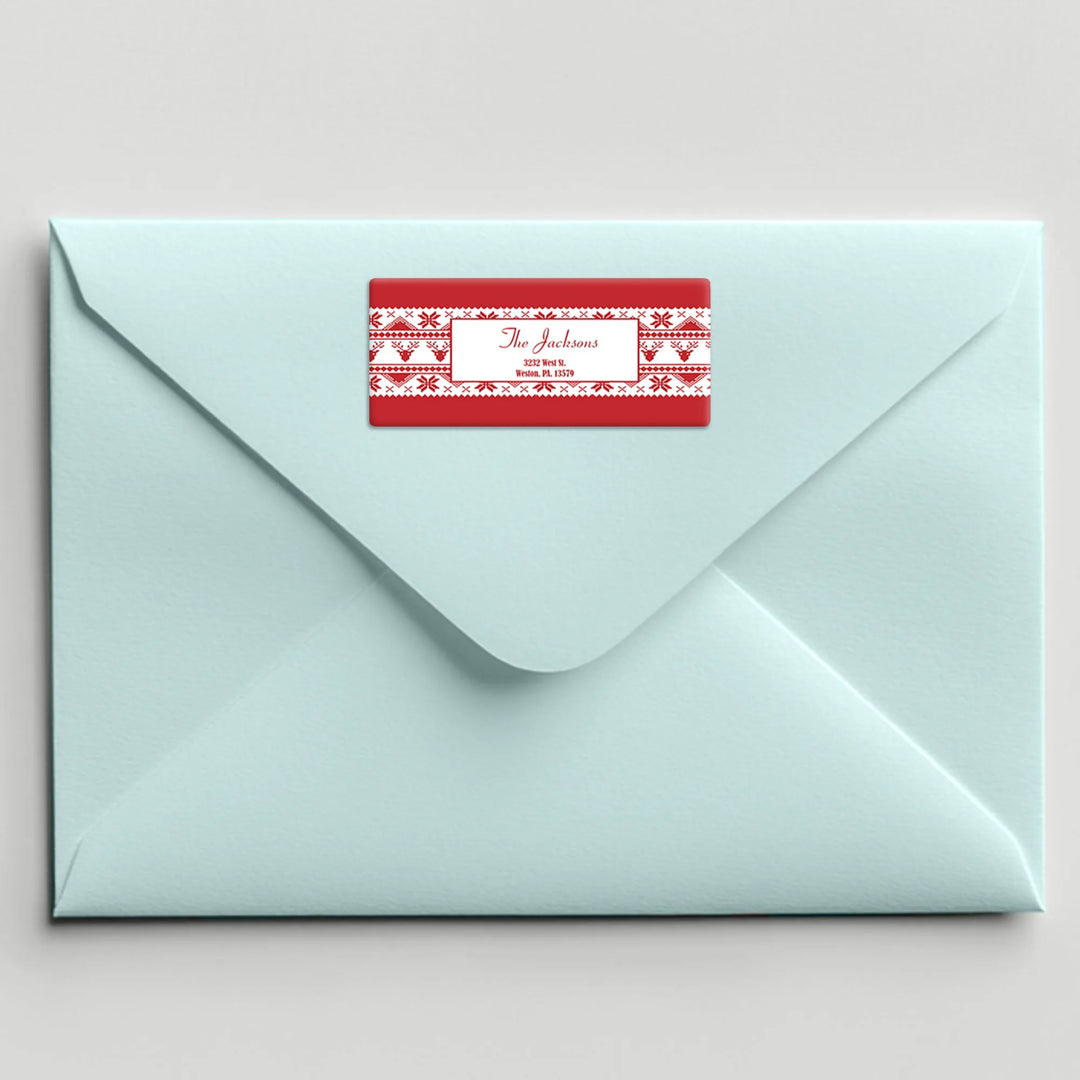Light blue envelope with a red ugly sweater address label on the back flap