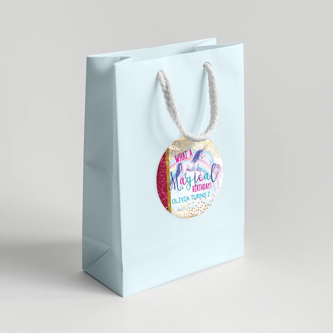 Light blue gift bag with unicorn birthday favor label, gold and pink party decoration
