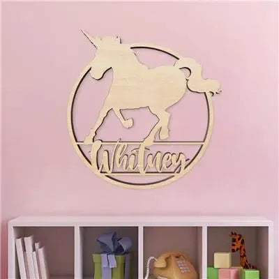 Wood unicorn name sign wall decor on pink wall above shelf in kids room