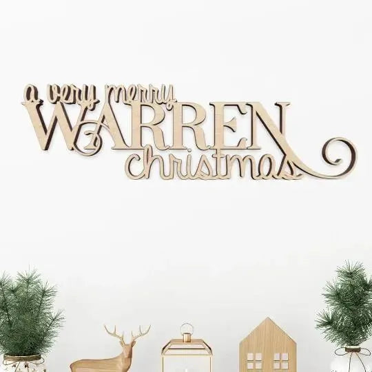 Personalized wood sign reading 'A Very Merry Warren Christmas' with festive holiday decor.