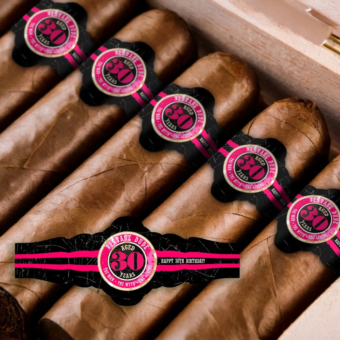 Box of cigars with custom black and pink 30th birthday cigar bands for vintage party
