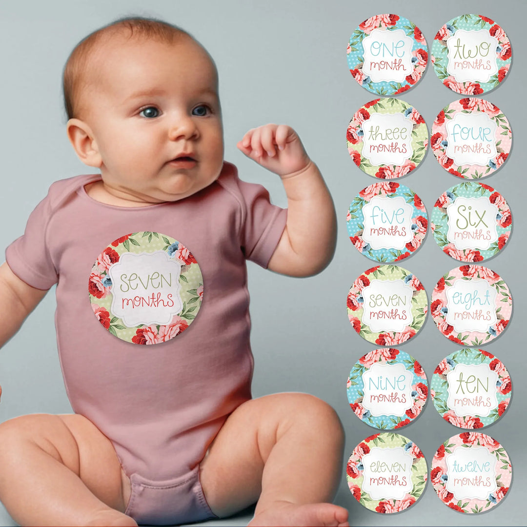 Baby wearing a floral vintage polka dot month sticker, with twelve monthly milestone stickers displayed.