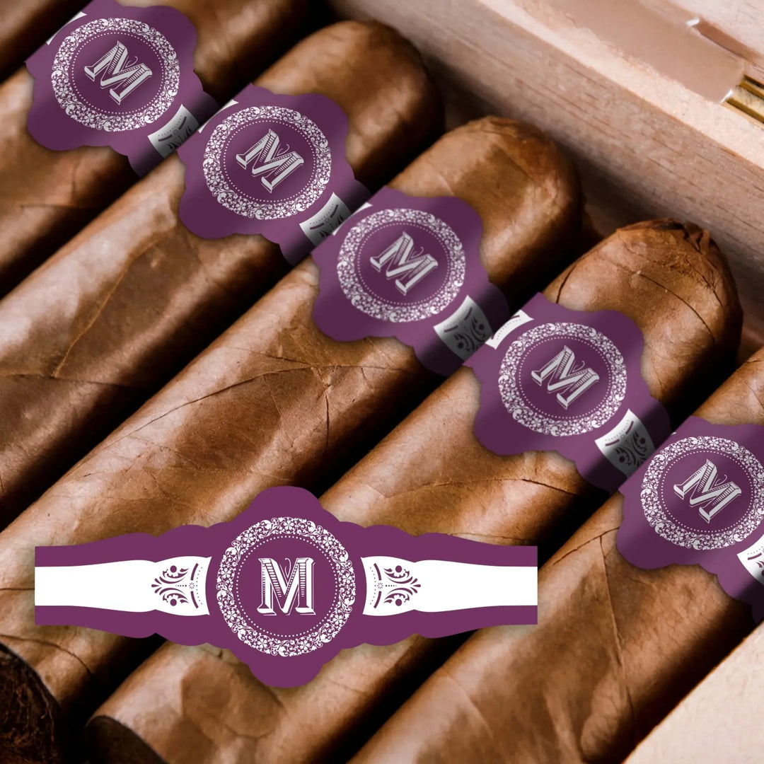 Vintage monogram wedding cigar bands with purple and white 'M' design on cigars in box