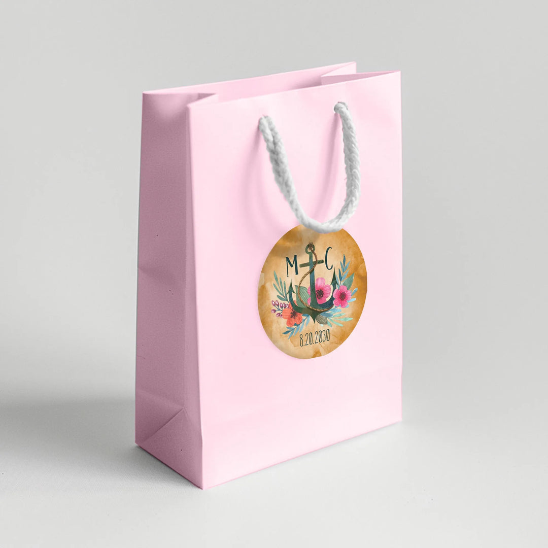 Pink gift bag with watercolor anchor wedding favor label and floral design