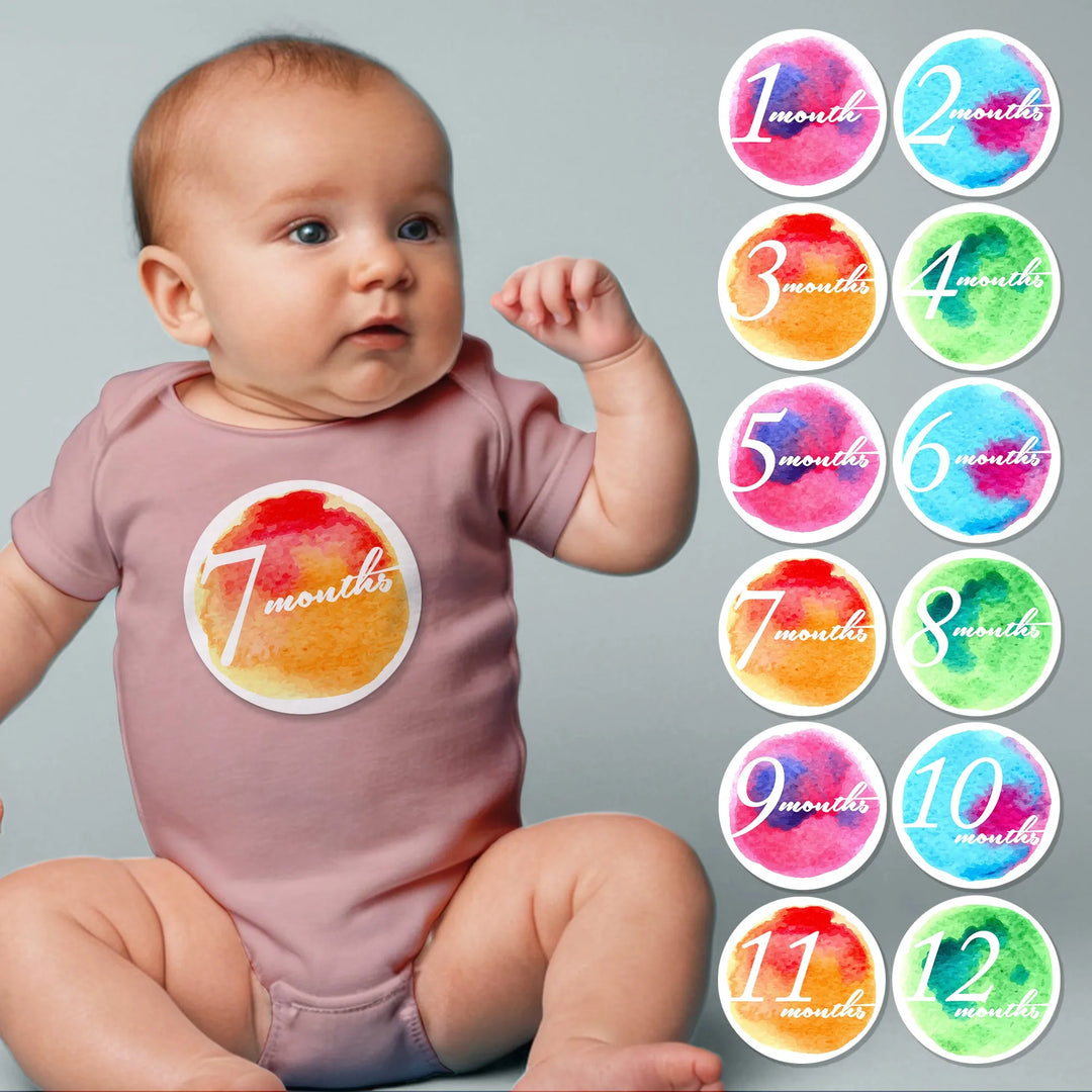 Baby wearing 7 months watercolor milestone sticker, set of monthly milestone stickers beside.