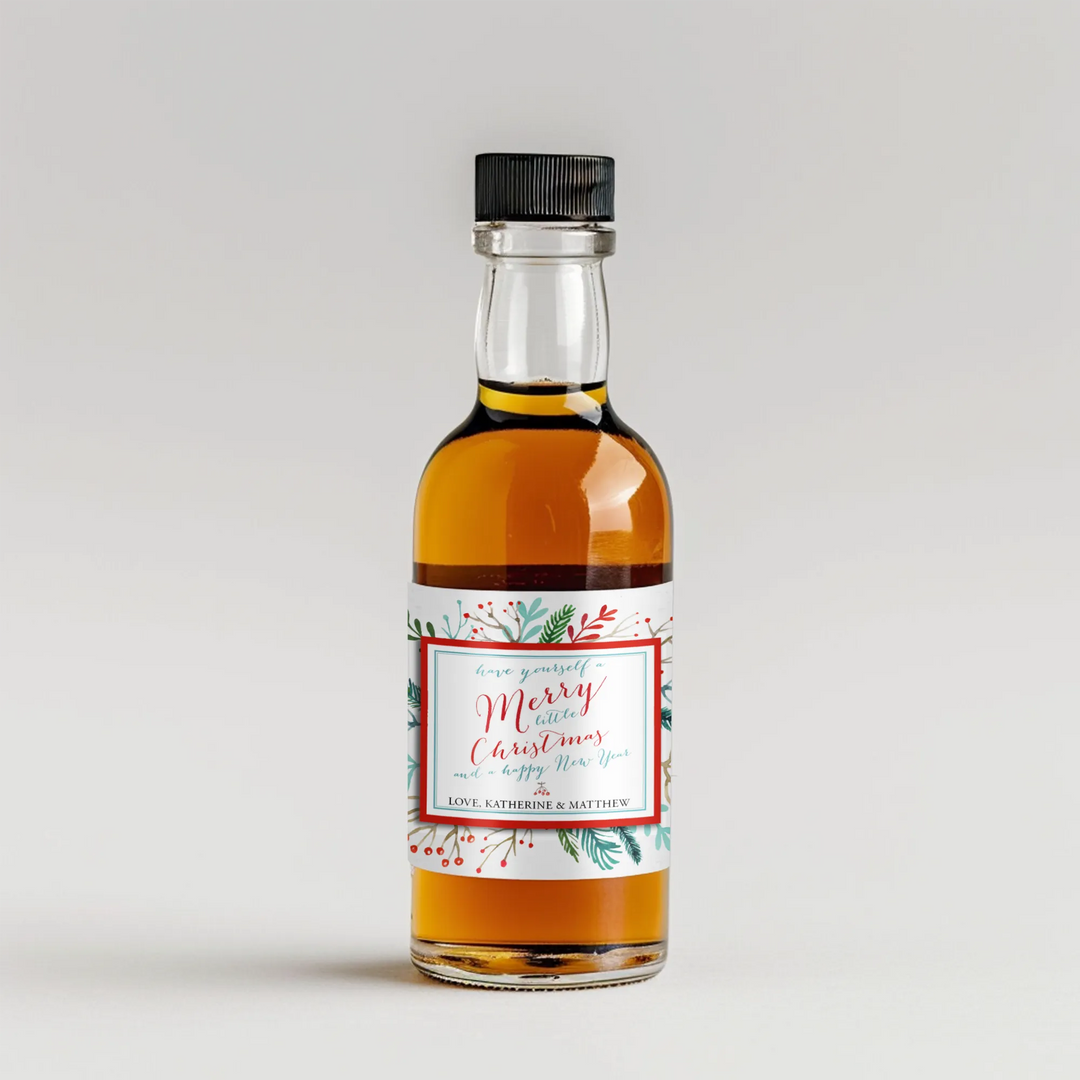 Holiday mini liquor bottle with watercolor bird and festive Christmas label on white background