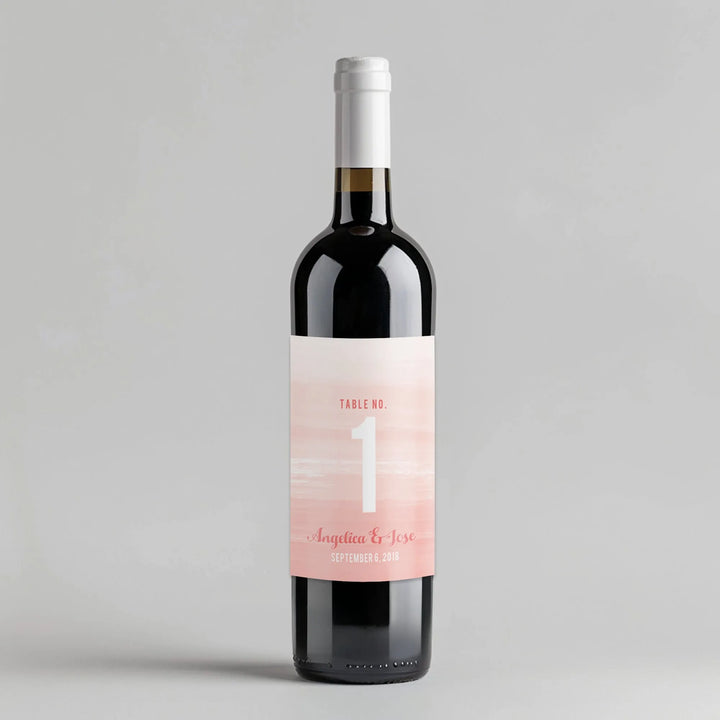 Wine bottle with pink watercolor ombre table number label for wedding decor