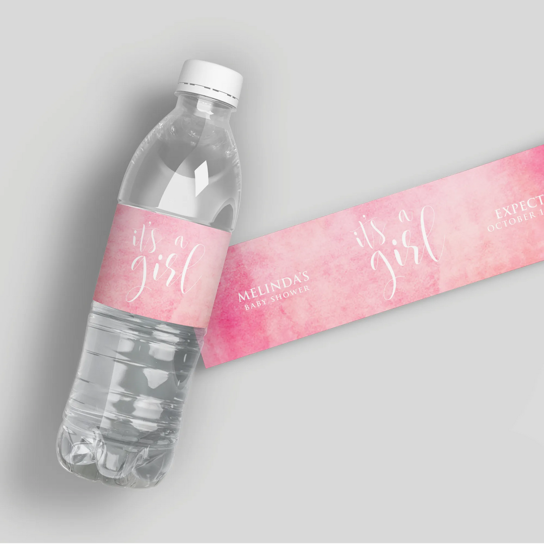 Pink watercolor baby shower water bottle label with script 'it's a girl' on a clear bottle
