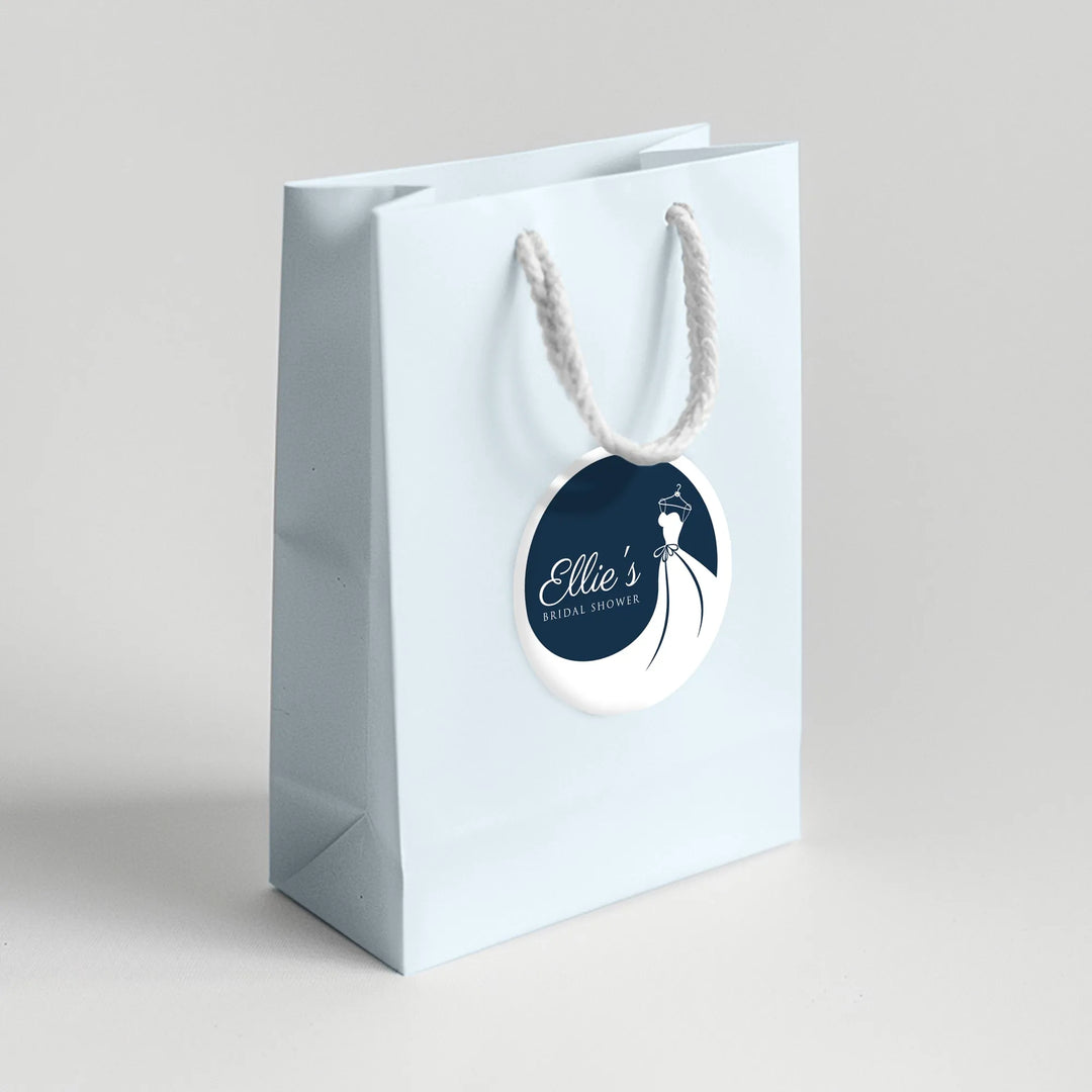 Light blue bridal shower favor bag with custom wedding dress label and white rope handle.