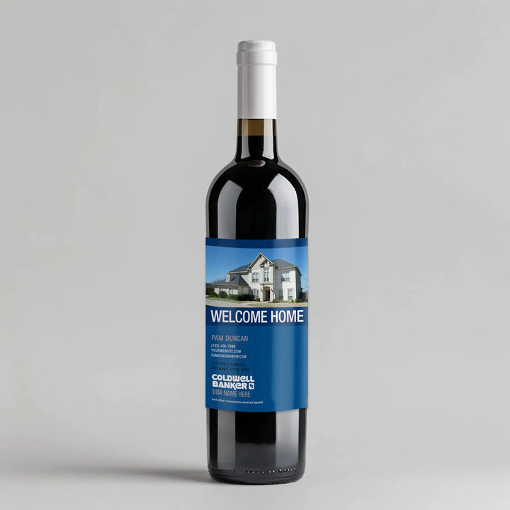 Wine bottle with Coldwell Banker Welcome Home blue real estate label and house photo