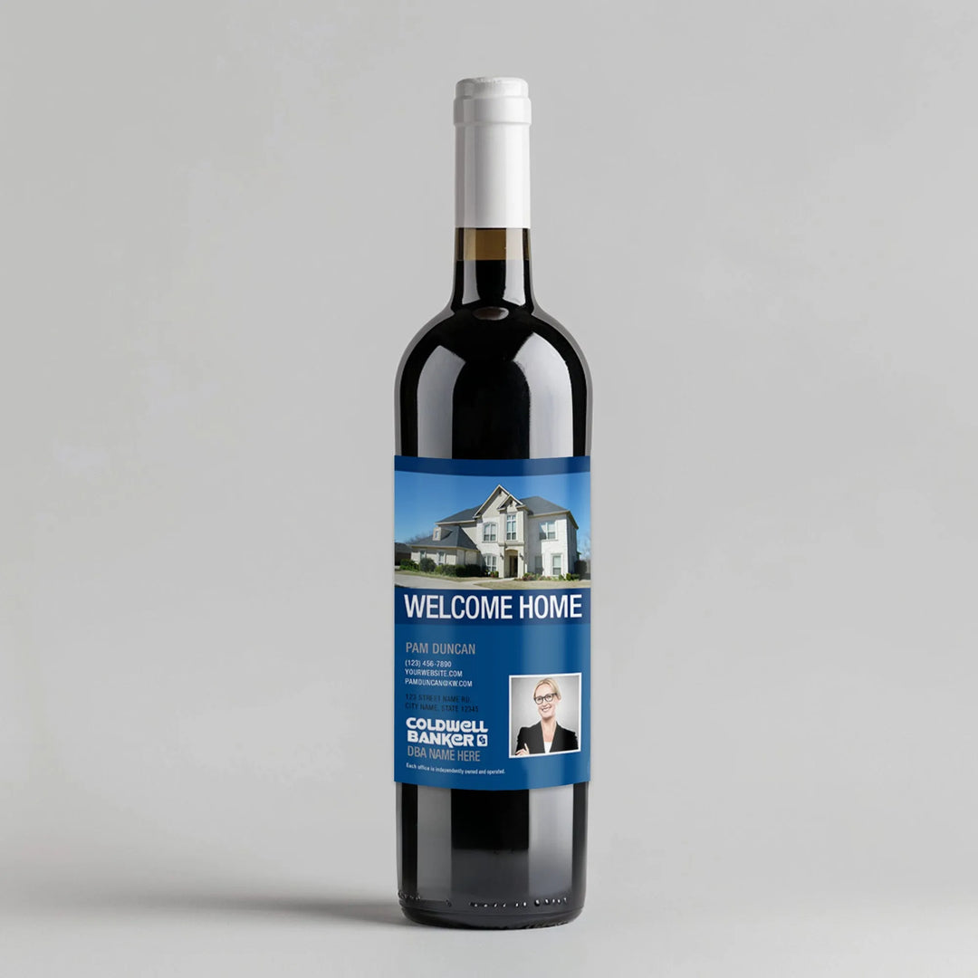 Wine bottle with Coldwell Banker welcome home real estate label, house photo, and agent info