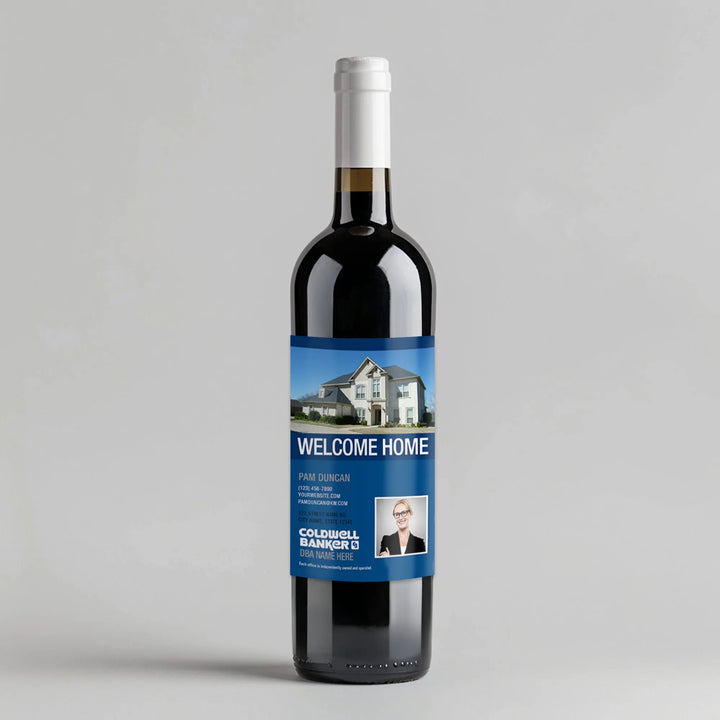 Wine bottle with Coldwell Banker welcome home real estate label, house photo, and agent info