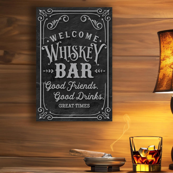 Welcome whiskey bar metal sign on wooden wall with lit cigar in ashtray and glass of whiskey on table