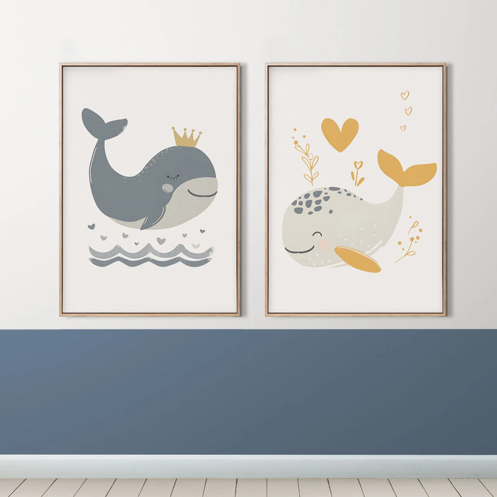 Pair of framed nursery wall art featuring cute cartoon whales with crown and heart designs