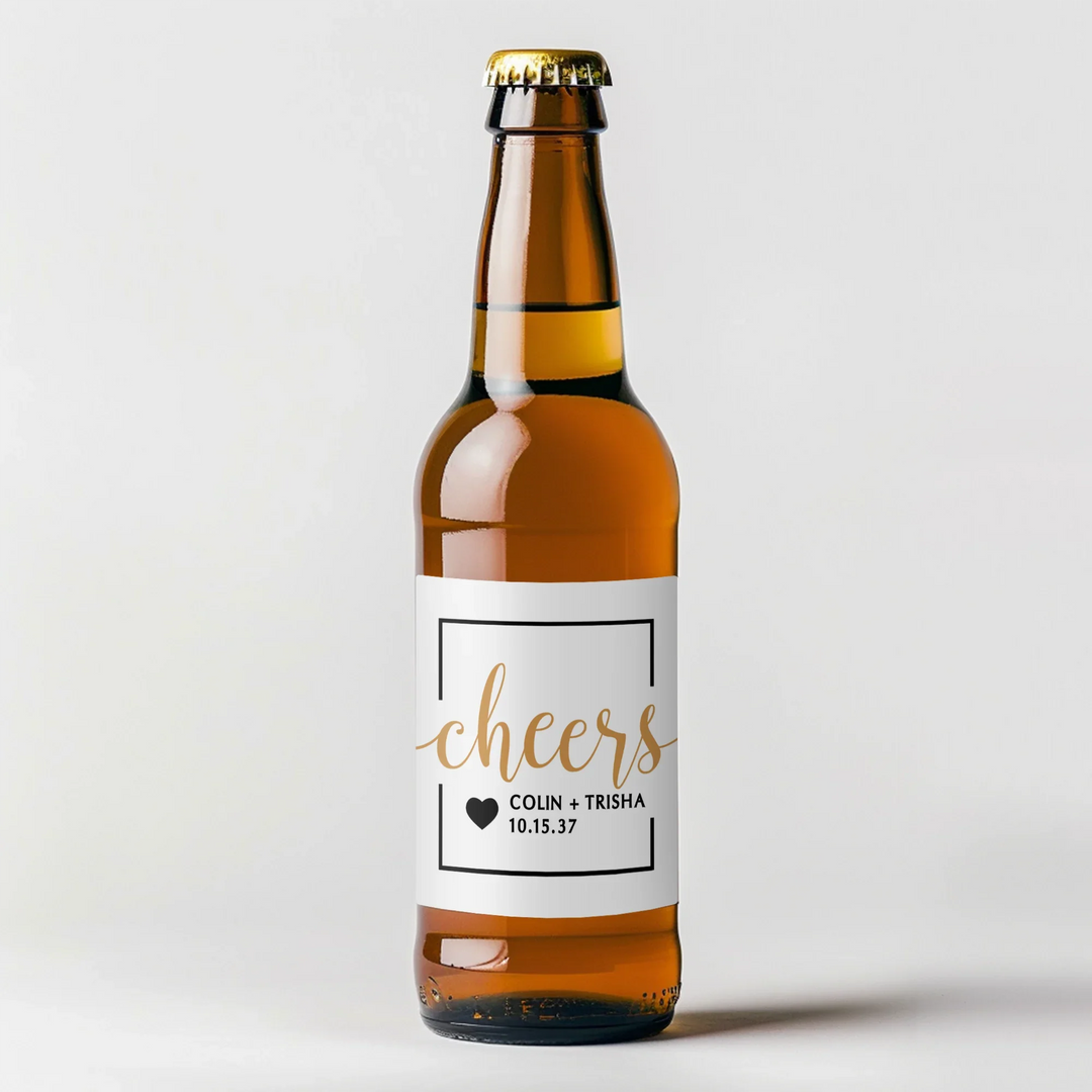 Personalized brown beer bottle with white cheers label and gold script design on plain background