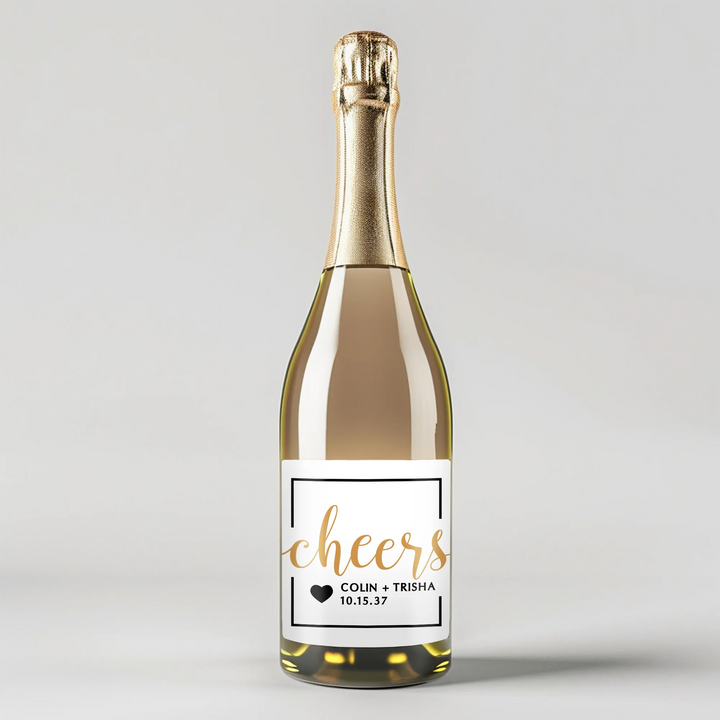Custom champagne bottle with gold foil and white cheers label, wedding date and heart graphic