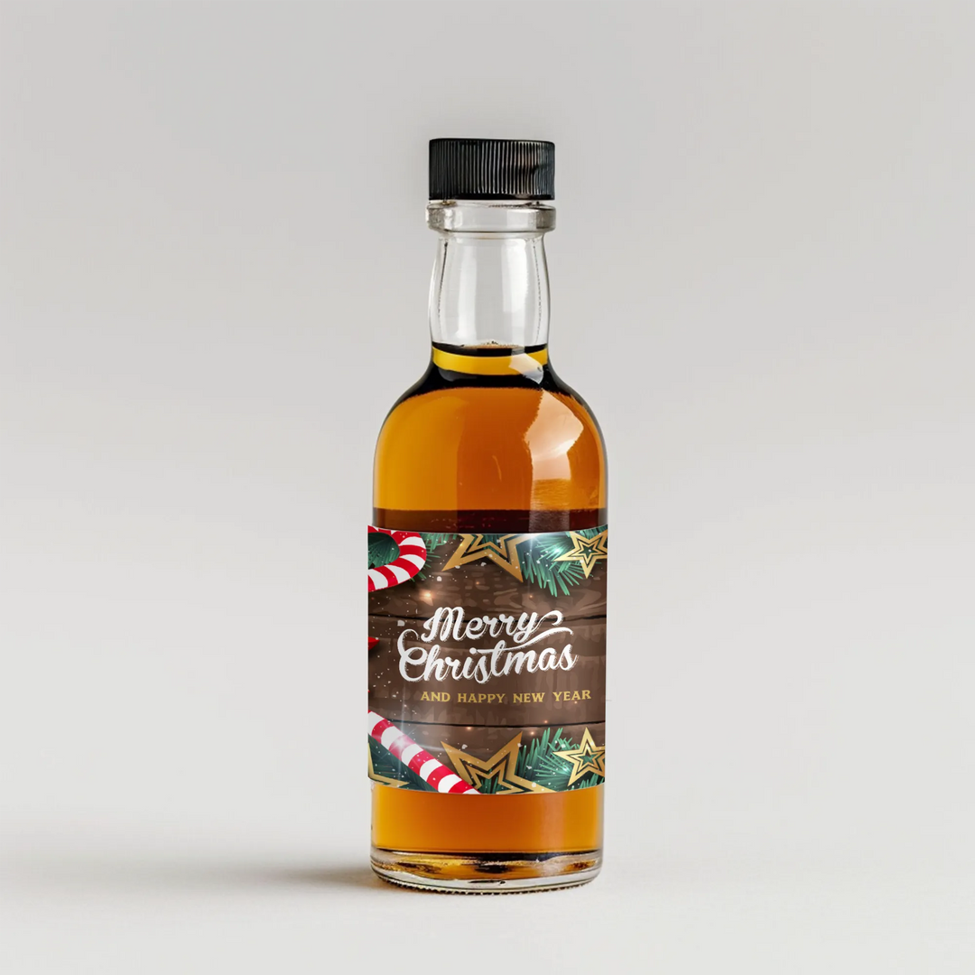 Mini liquor bottle with Merry Christmas label, candy canes, pine, and star cookies