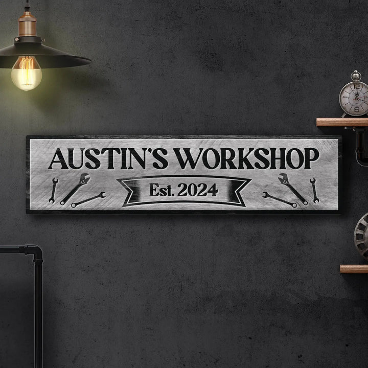 Industrial metal workshop sign reading Austin's Workshop Est. 2024 with wrench graphics on dark wall