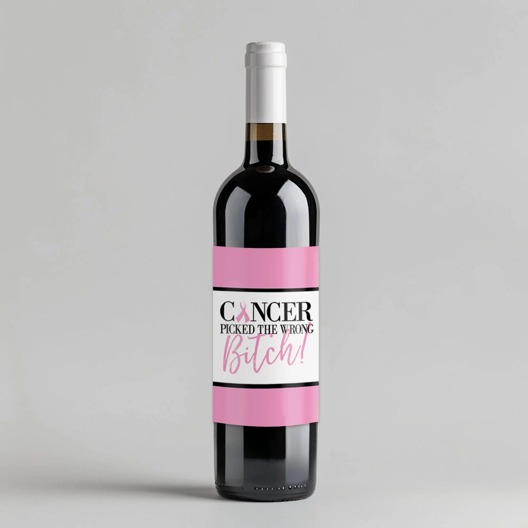 Wine bottle with pink cancer awareness label that reads 'Cancer picked the wrong bitch'.